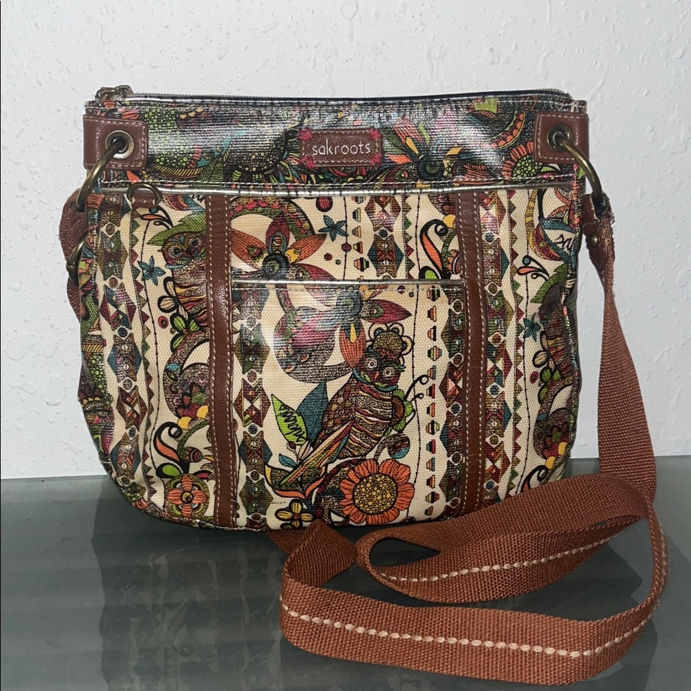Sakroots crossbody bag with an owl and floral print.